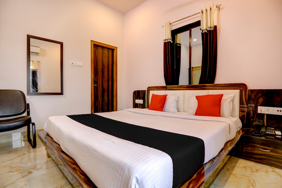 Heritage Luxury Room at Sri Karni Heritage Resort with Queen Bed and polished wood headboard