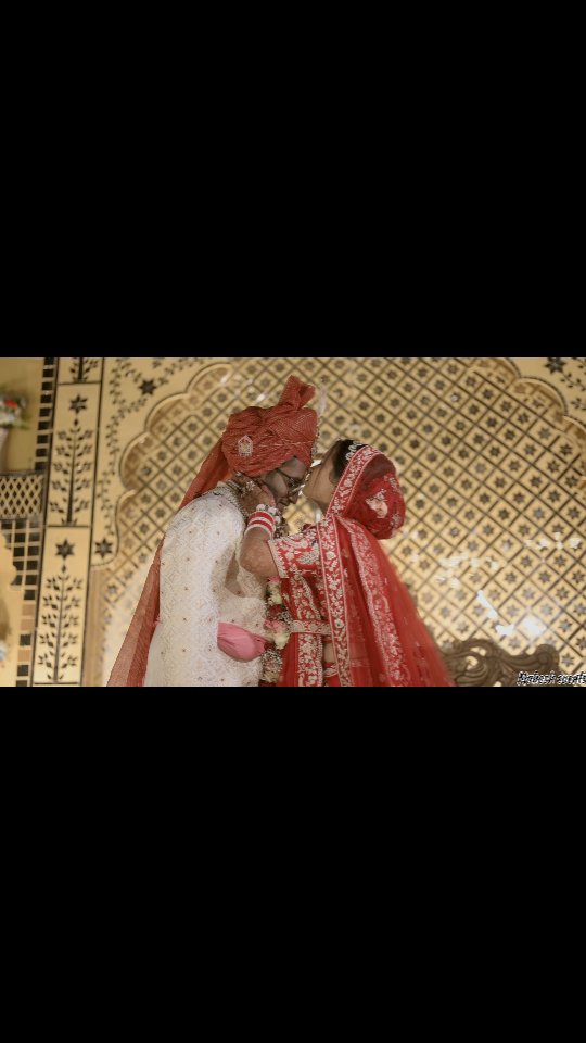 Royal Bride and Groom portrait against carved jali arch at Sri Karni Heritage Resort